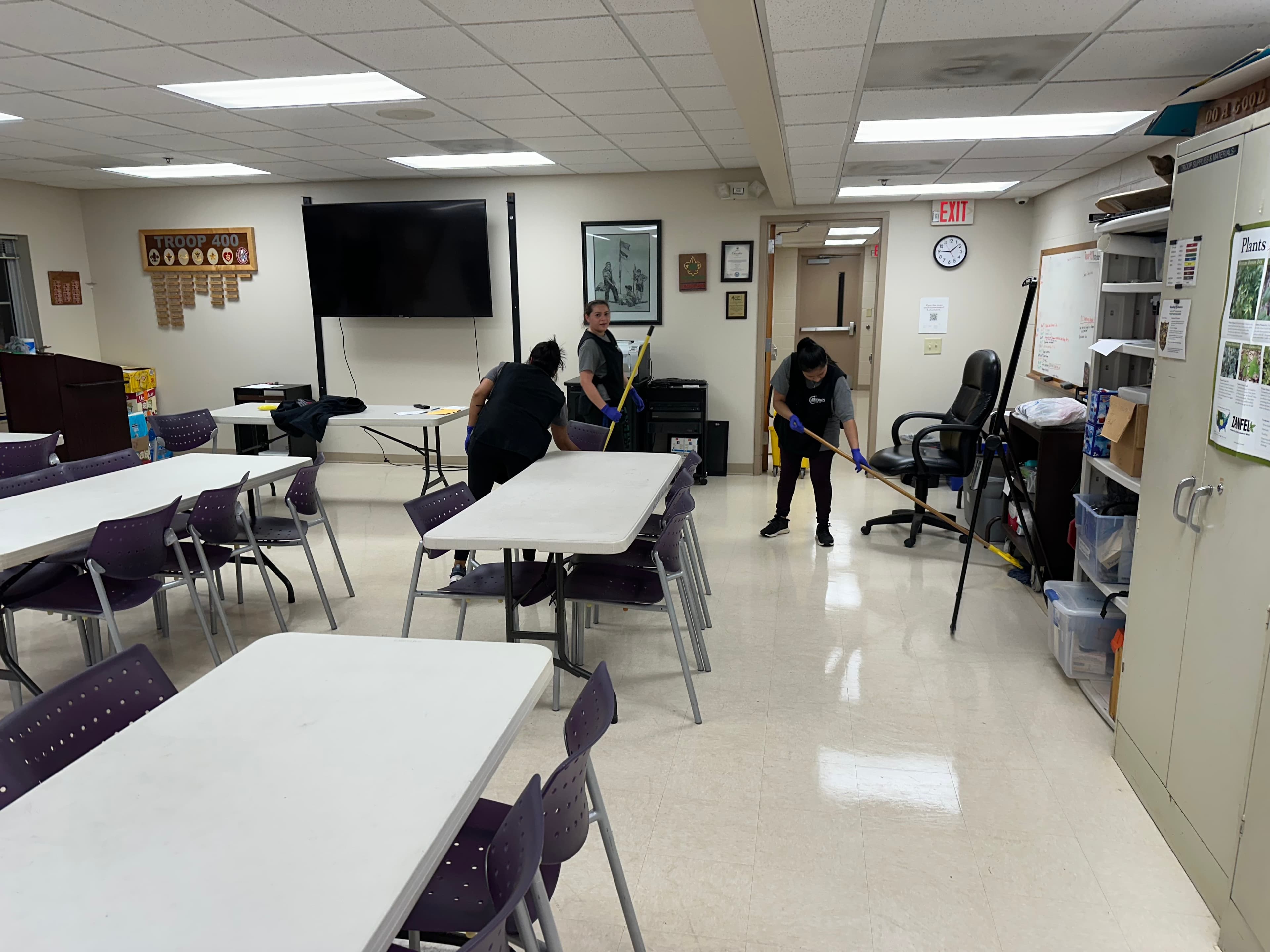 Janitorial service team cleaning a commercial office space